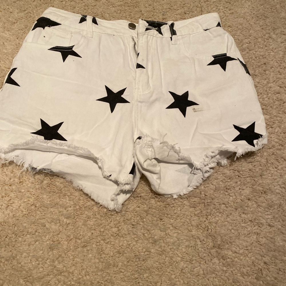 White jean shorts with black stars.
